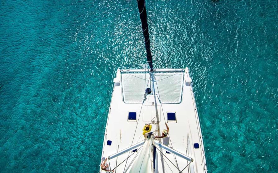 Drone view above sailboat on blue water in Barbados